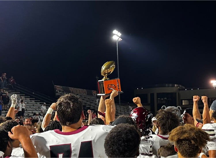 picture of football players holding a trophy 